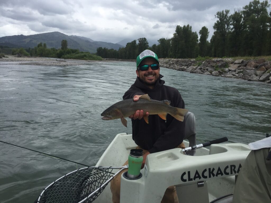 snake river fly fishing guide holding a fish